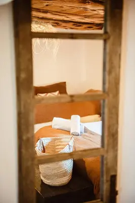 a bunk bed with two towels on top of it at Ranch Campo Palombaggia in Porto-Vecchio