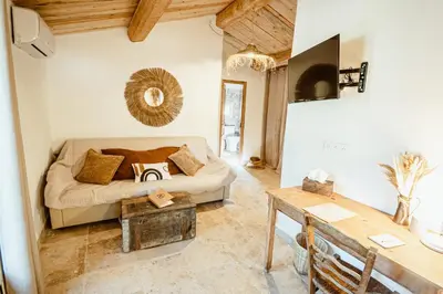 a living room with a couch and a table at Ranch Campo Palombaggia in Porto-Vecchio
