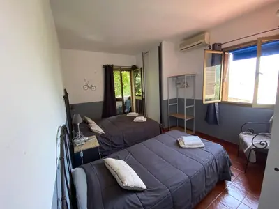 a bedroom with two beds and a window at Hotel gite d'etape San Pasquale in Conca