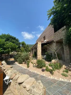 a building with a stone walkway in front of it at Hotel gite d'etape San Pasquale in Conca