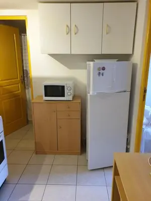 a kitchen with a white refrigerator and a microwave at casabellavista in Bonifacio