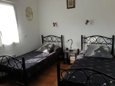 a bedroom with two beds and a window at casabellavista in Bonifacio