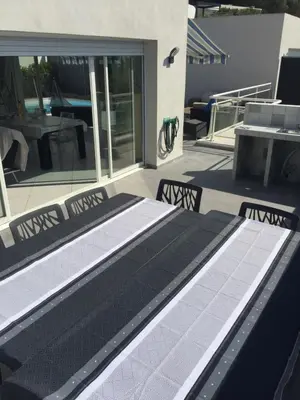 a patio with black and white flooring on a house at Villa cote plage in Ajaccio