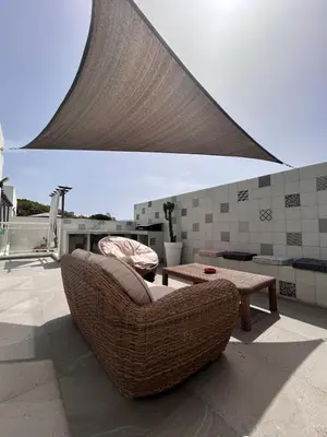 a patio with a couch and a table on a roof at Villa cote plage in Ajaccio