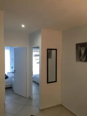 a room with a mirror on the wall and a bedroom at Villa cote plage in Ajaccio