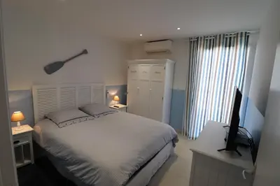 a bedroom with a bed and a television on a desk at Bonifacio 5 minutes du port et plage - clim & piscine in Bonifacio