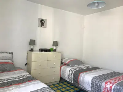 a bedroom with two beds and a dresser in it at Maison entière tout équipé 4 chambre possibilité de 10 couchage Venaco Centre Corse in Venaco