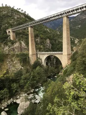 a bridge with a train on it over a river at Maison entière tout équipé 4 chambre possibilité de 10 couchage Venaco Centre Corse in Venaco
