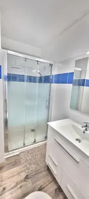 a bathroom with a shower and a toilet and a sink at Appartement Ajaccio vue mer panoramique in Ajaccio
