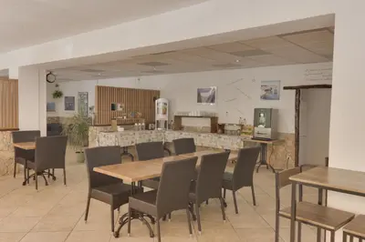 a dining room with wooden tables and chairs at Hotel des Etrangers in Bonifacio
