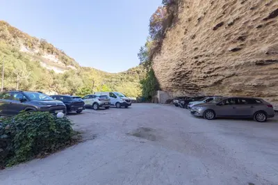 a bunch of cars parked in front of a mountain at Hotel des Etrangers in Bonifacio