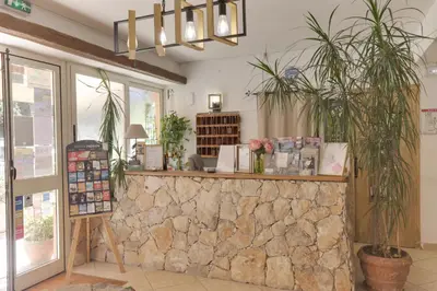 a restaurant with a stone counter with potted plants at Hotel des Etrangers in Bonifacio