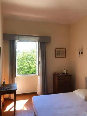 a bedroom with a bed and a window at A Loghja Di Cavallo Morto in Bonifacio