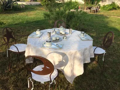 a table with a white table cloth and chairs sidx sidx sidx sidx at A Loghja Di Cavallo Morto in Bonifacio