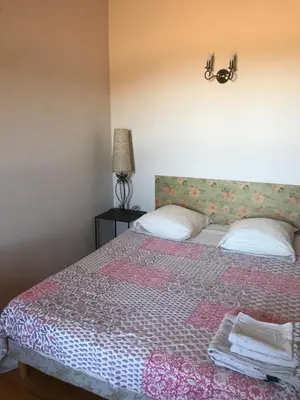 a bedroom with a bed with two pillows on it at A Loghja Di Cavallo Morto in Bonifacio