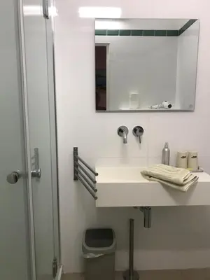 a bathroom with a sink and a mirror at A Loghja Di Cavallo Morto in Bonifacio