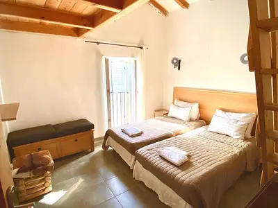 a bedroom with two beds and a window at Casa Orani in Ponte-Leccia