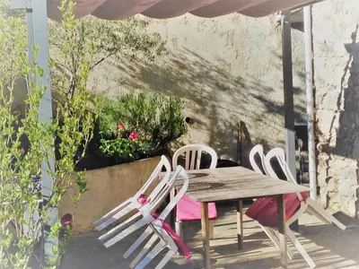 a wooden table and chairs on a patio at Casa Orani in Ponte-Leccia