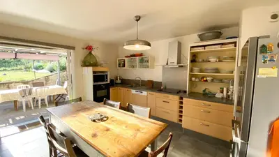 a kitchen with a wooden table and a dining room at Casa Orani in Ponte-Leccia