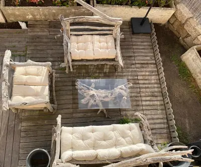 an overhead view of chairs and tables on a wooden deck at Magnifique appartement devant la plage in Propriano