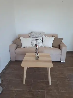a coffee table in a living room with a couch at gite tomasini sabrina zirilla in Monacia-dʼAullène