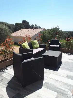 two chairs and a table on a patio at gite tomasini sabrina zirilla in Monacia-dʼAullène