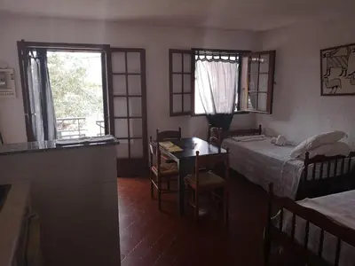 a room with a table and chairs and a window at Motel Logis d'Abartello in Olmeto