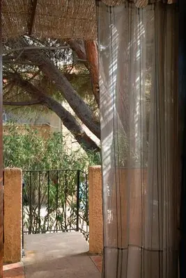an open door to a balcony with a tree at Motel Logis d'Abartello in Olmeto
