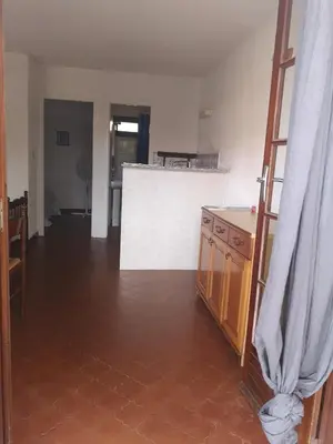a living room with a tile floor and a kitchen at Motel Logis d'Abartello in Olmeto