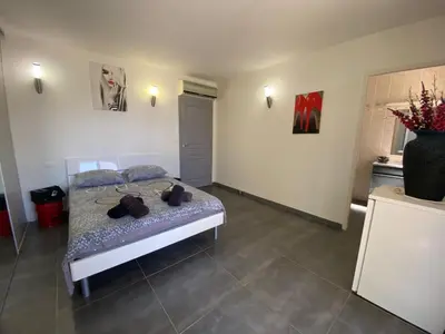 a bedroom with a bed and a vase of flowers at Chambres du Gozzi in Afa