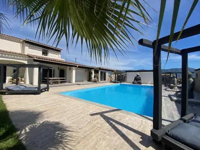 a swimming pool in front of a house at Chambres du Gozzi in Afa