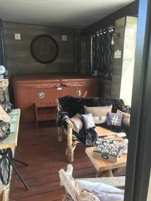 a living room with a couch and a table at Chambres du Gozzi in Afa