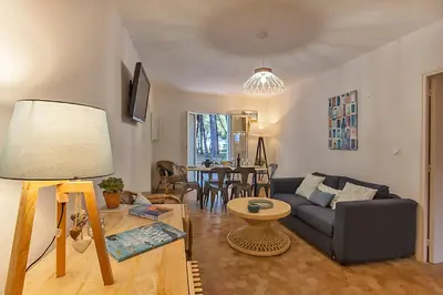 a living room with a couch and a table at MAISONS BORD DE MER- MARINE DE SORBO - Gîtes 3 épis in Pinarellu