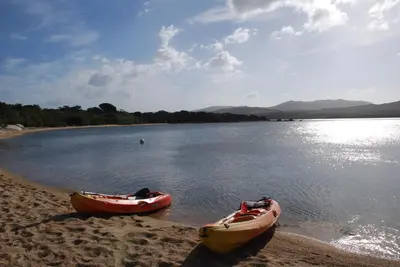 two canoes on the shore of a body of water at Residence Ribellinu in Pianottoli-Caldarello