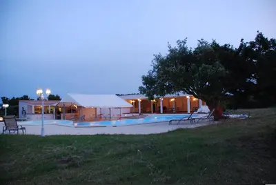 a building with a swimming pool in front of it at Residence Ribellinu in Pianottoli-Caldarello