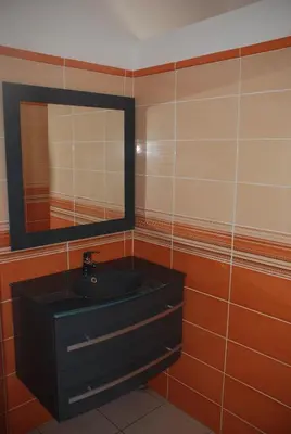 a bathroom with a black sink and a mirror at Residence Ribellinu in Pianottoli-Caldarello