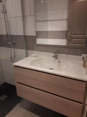 a bathroom with a white sink and a shower at 10 Casa scaledda 3 étoiles in Porto-Vecchio