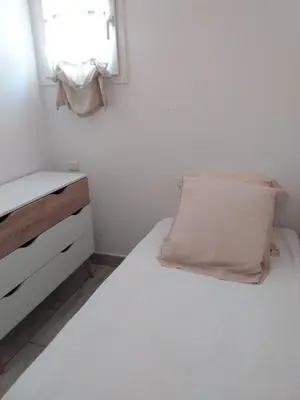 a white bedroom with a bed and a window at 10 Casa scaledda 3 étoiles in Porto-Vecchio