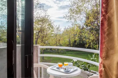 a table with two glasses of orange juice on a balcony at Chez Walter in Lucciana