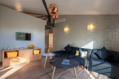 a living room with a blue couch and a table at Chez Walter in Lucciana