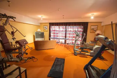 a room with a gym with exercise equipment in it at Chez Walter in Lucciana