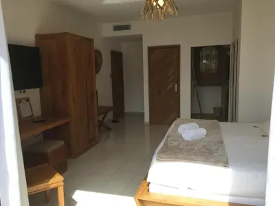 a bedroom with a bed and a dresser and a television at Villa Torrella in Mezzavia