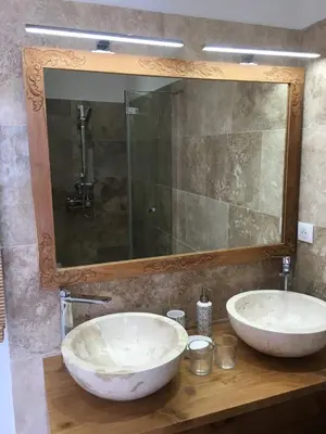 two sinks on a wooden counter with a mirror at Villa Torrella in Mezzavia