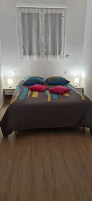 a bedroom with a bed with pillows and a window at corse location in Linguizzetta