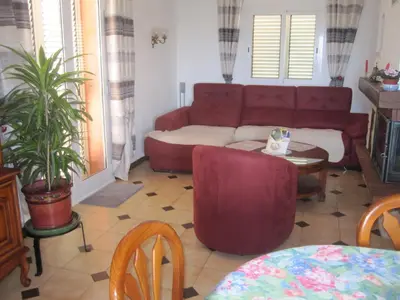 a living room with a red couch and a table at Villa Pastriccialone in Afa