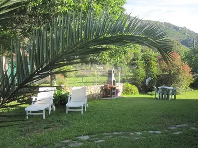 a group of chairs sitting in a yard at Villa Pastriccialone in Afa