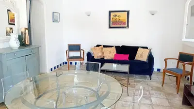 a living room with a glass table and a couch at soleil et farniente in Cervione