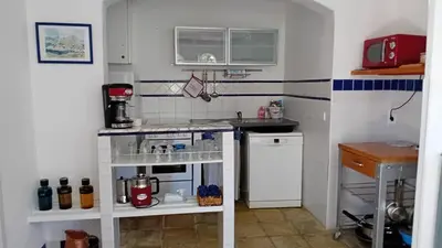 a small kitchen with a stove and a sink at soleil et farniente in Cervione
