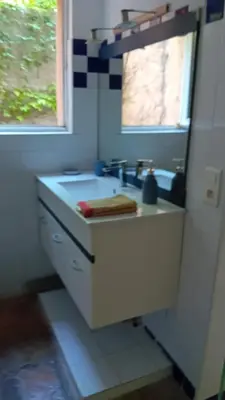 a bathroom with a sink and a window at soleil et farniente in Cervione
