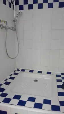 a shower in a bathroom with a tile floor at soleil et farniente in Cervione